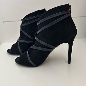 Black size 8 heeled booties. Open toed with back zip. Great fall/winter piece.